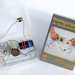 Die aufgebaute Alarmanlage liegt neben der Experimentierschachtel